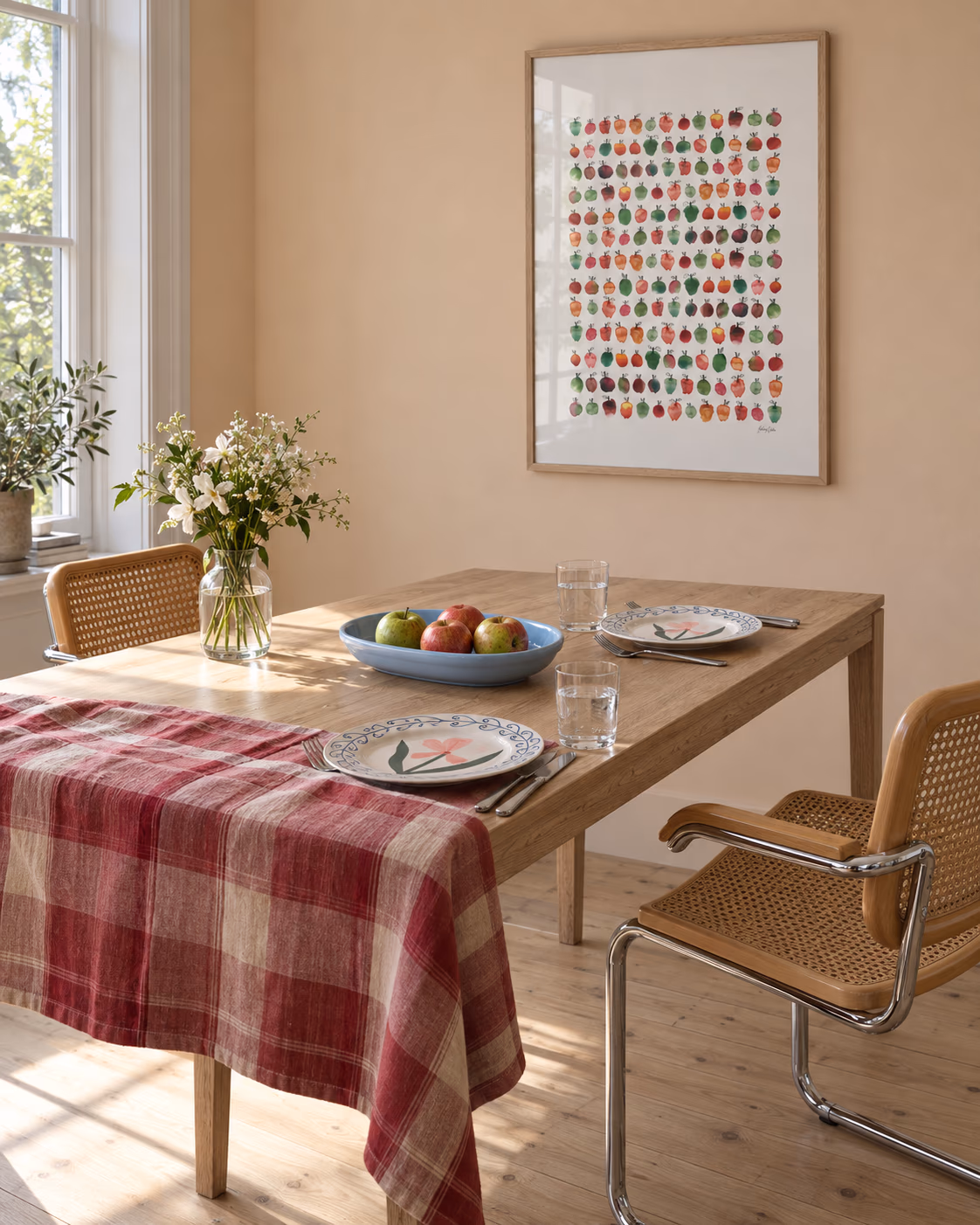 Massa Äpplen by Hedvig Wallin framed above a dining table