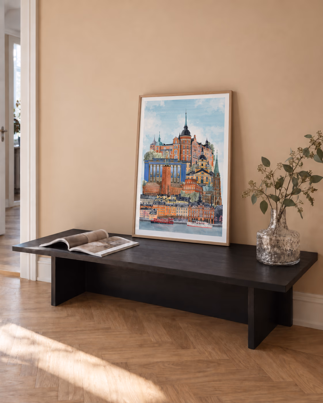Stockholm by Ishtar Bäcklund Dakhil framed on a low black bench against a peach wall