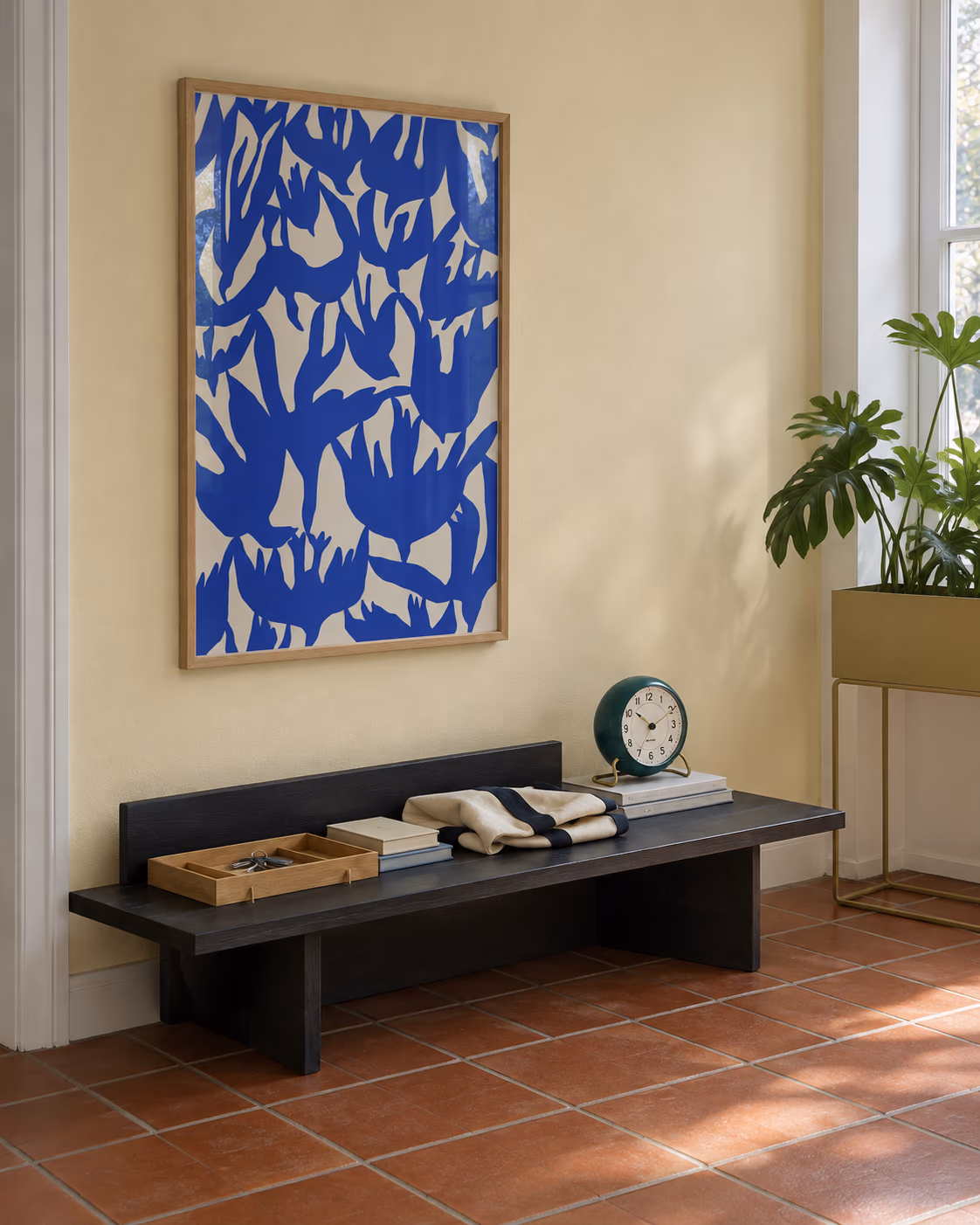 Swallow Dive by Helene Brox framed above a low hallway bench