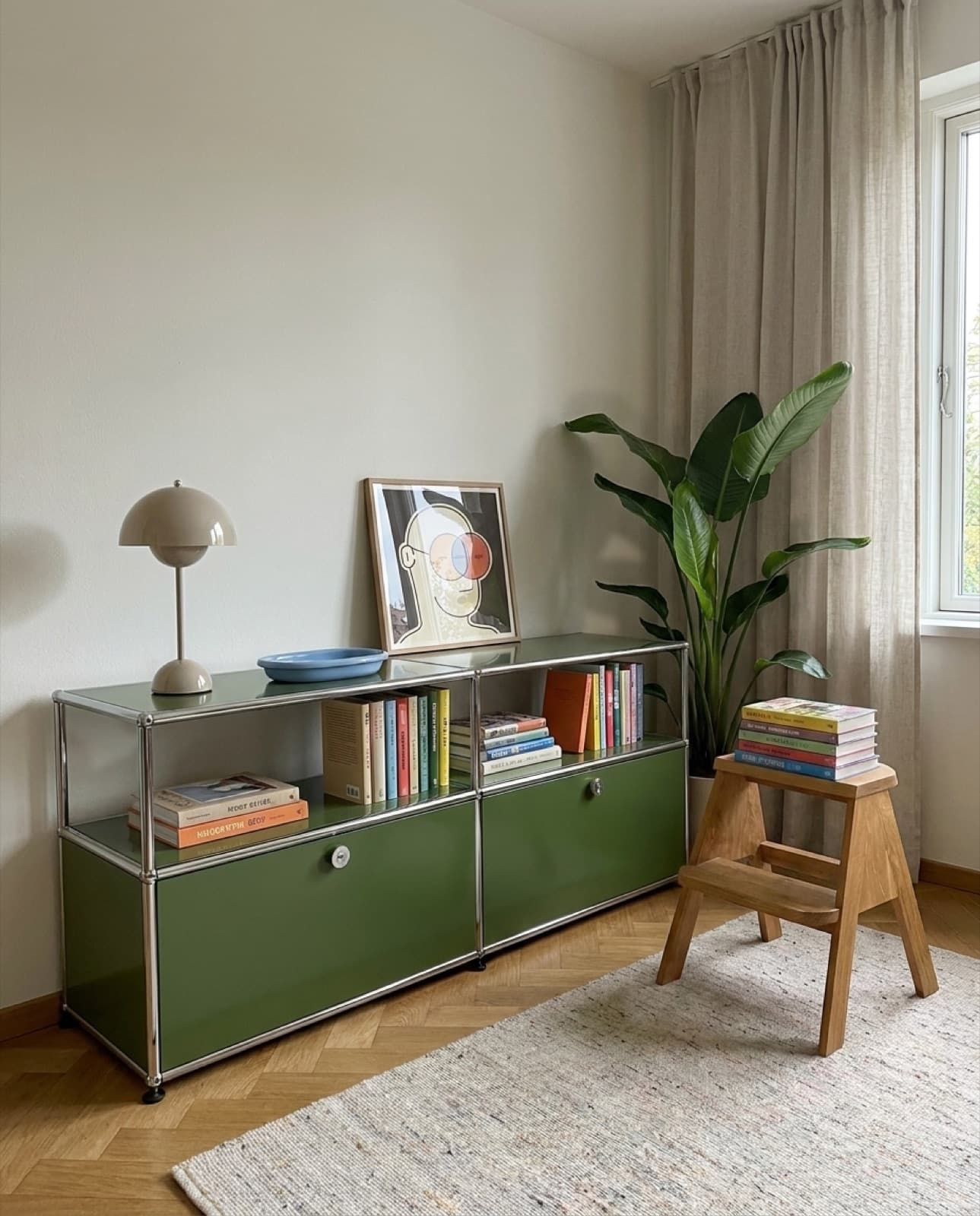 Eye Nose Eye leaning on an olive green sideboard filled with books